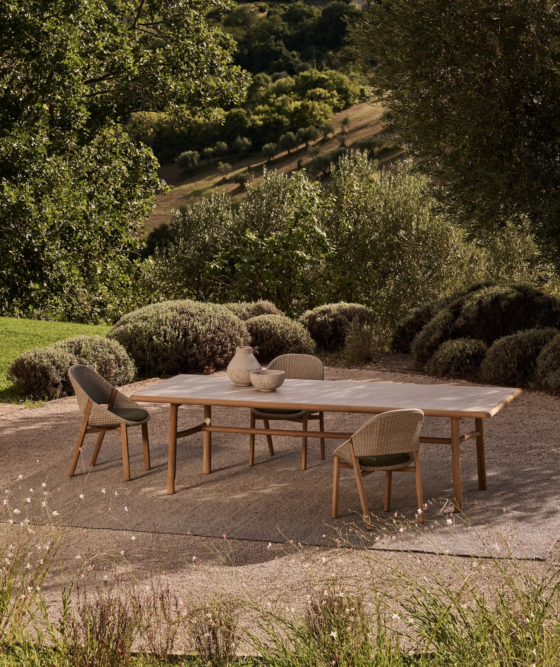 Tribù Elio sofas and lounge chairs with woven shells and deep cushions on an open terrace